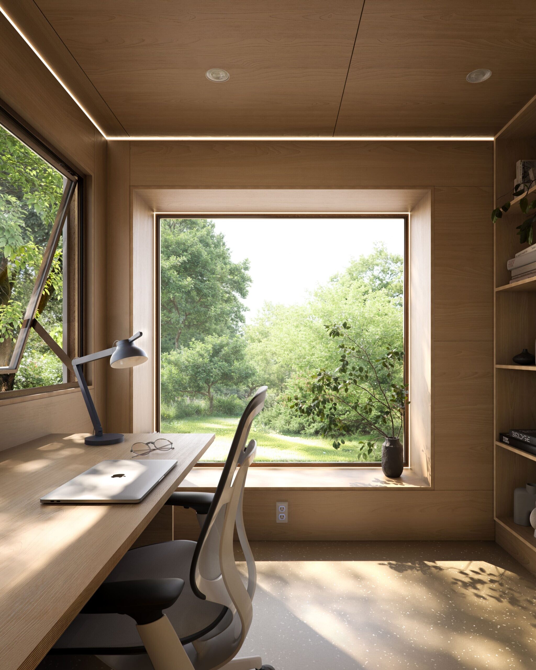 Minimalist workspace with large window overlooking lush greenery.